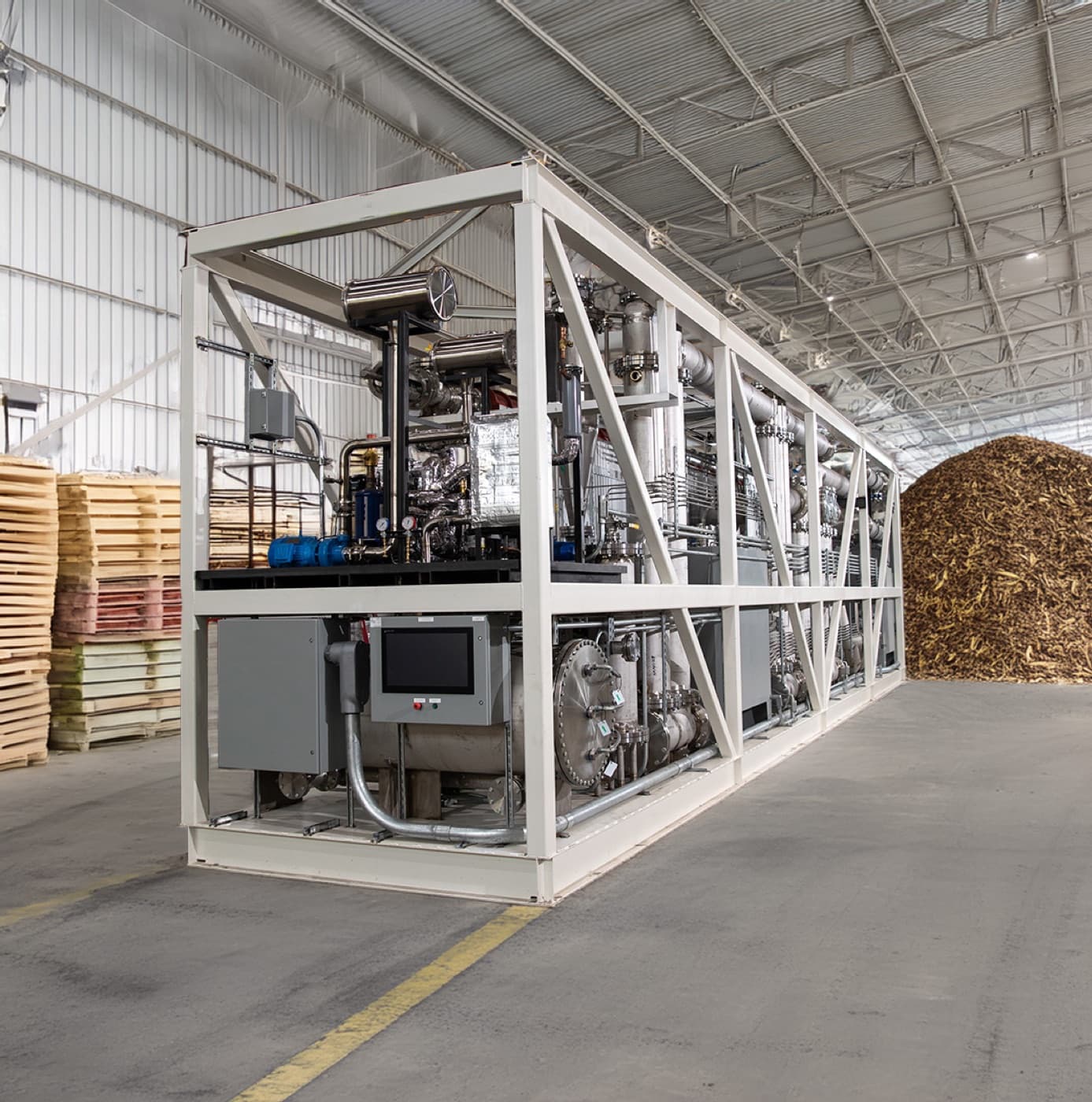 LOCOAL industrial Rainmaker pyrolysis unit inside a wood-processing facility.